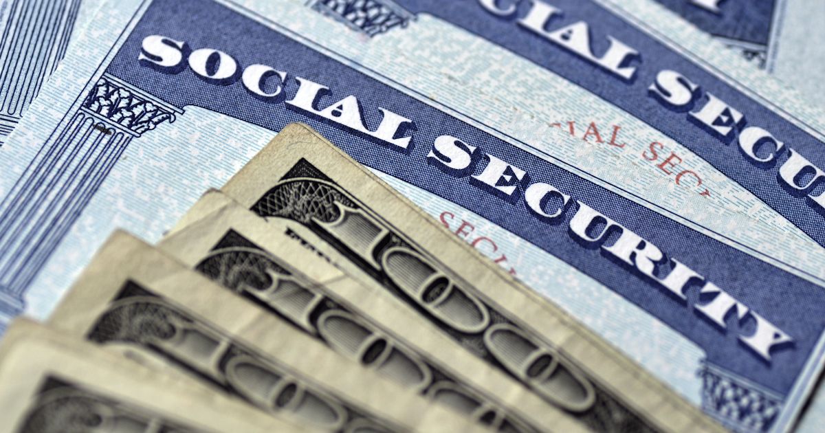 Detail of several Social Security Cards and cash money symbolizing retirement pensions financial safety